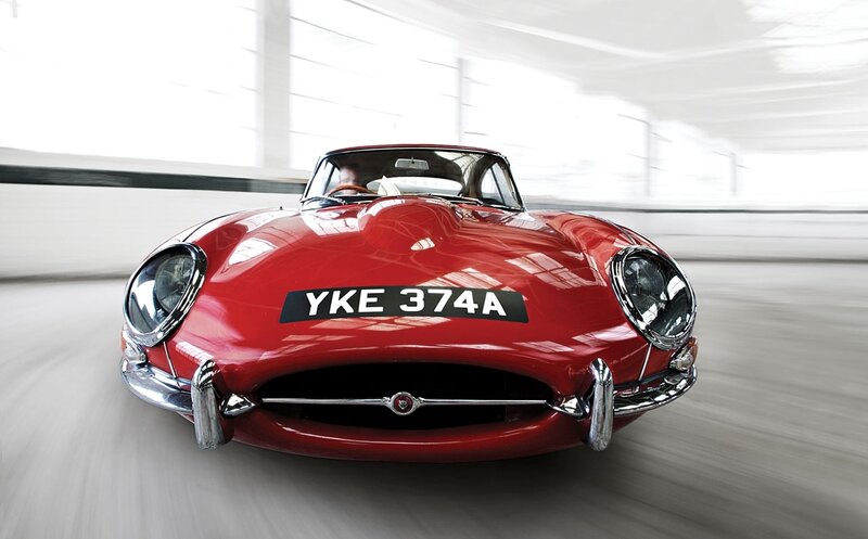 Red Jaguar E-Type in motion