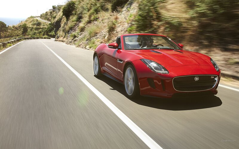 Red Jaguar F-Type driving on road