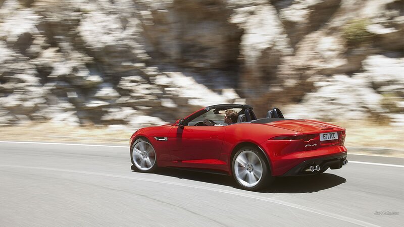 Red Jaguar F-Type driving on road