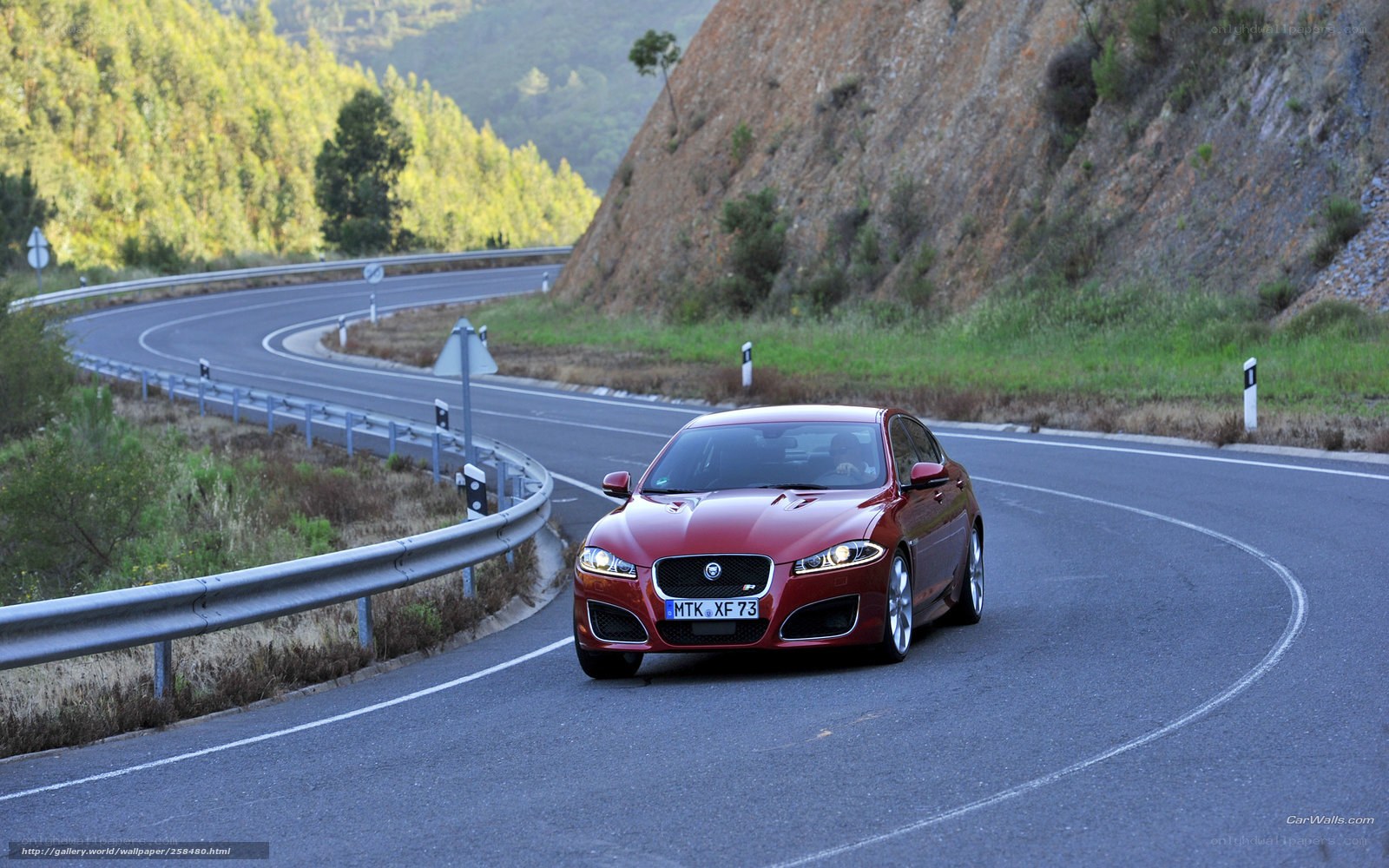 Red Jaguar on winding road