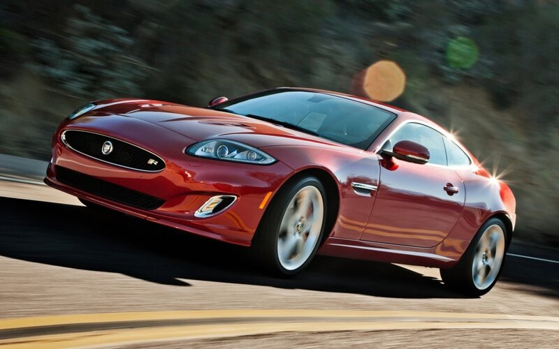 Red Jaguar sports car in motion