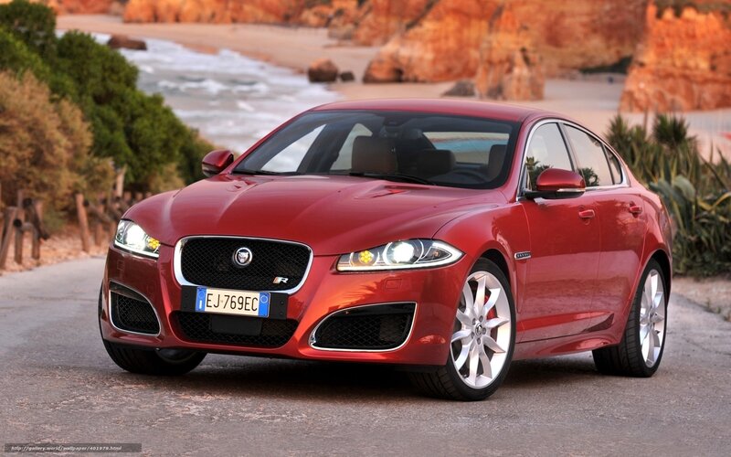 Red Jaguar XF on coastal road