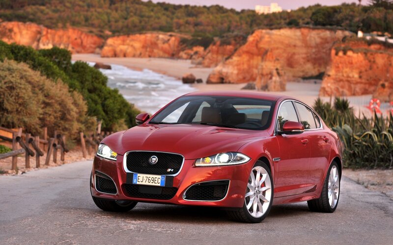 Red Jaguar XF on coastal road