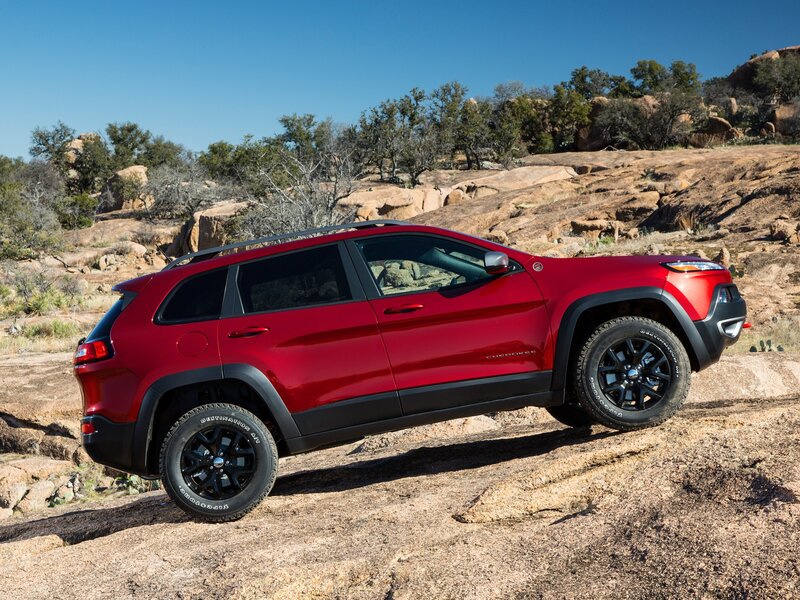 Red Jeep Cherokee on rocky terrain
