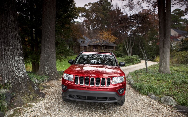 Red Jeep Compass on gravel path