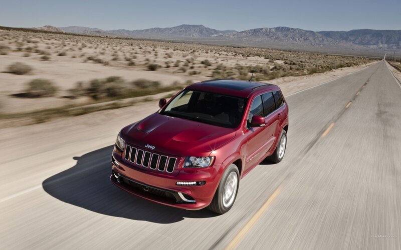 red jeep driving on desert road