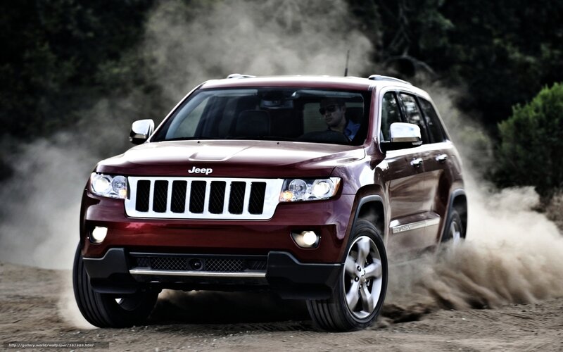 Red Jeep driving on dirt road