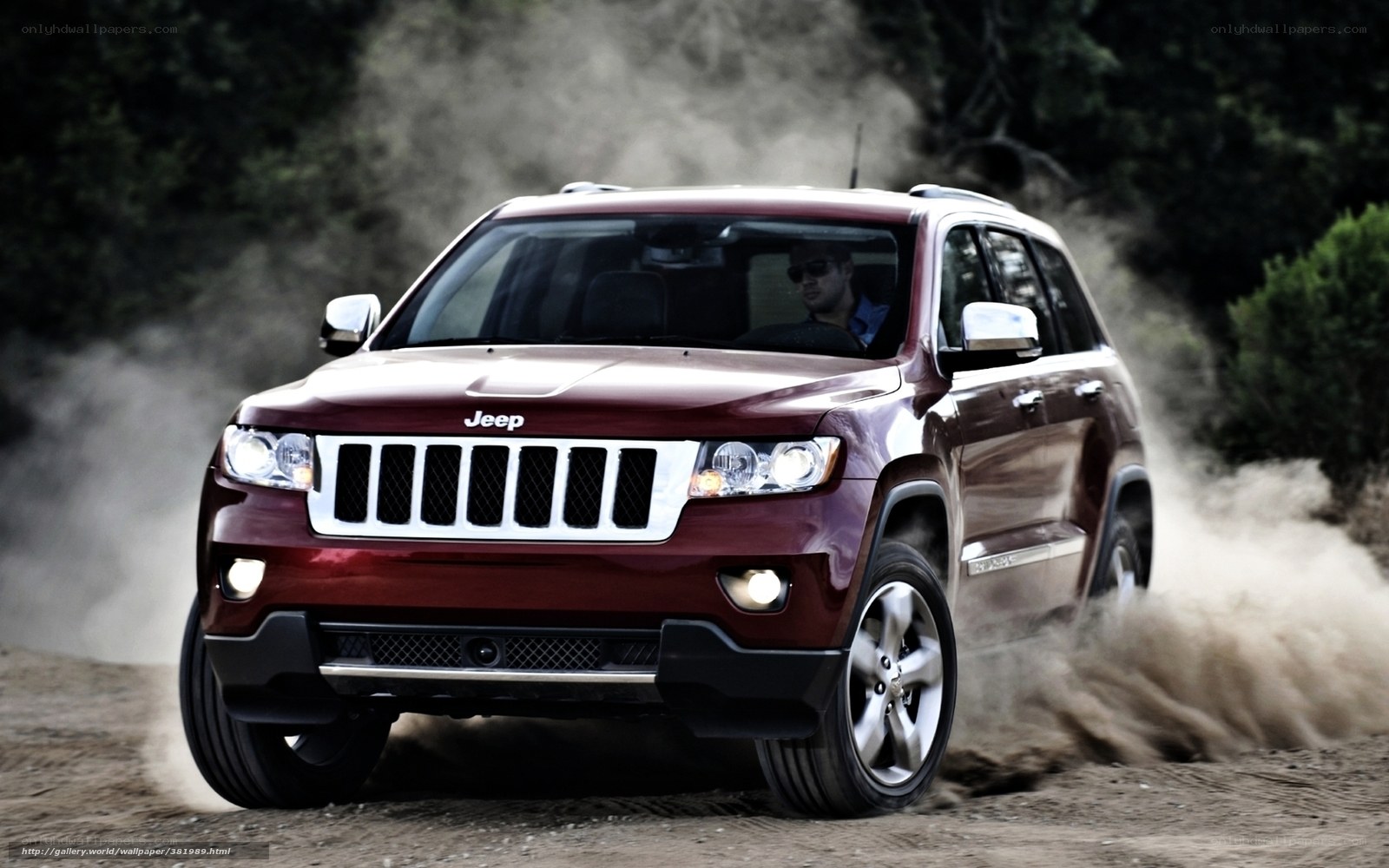 Red Jeep driving on dirt road