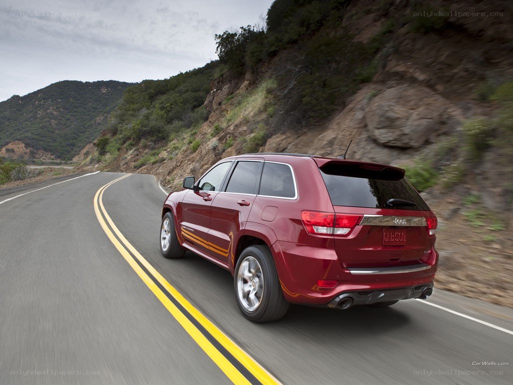 red jeep driving on mountain road