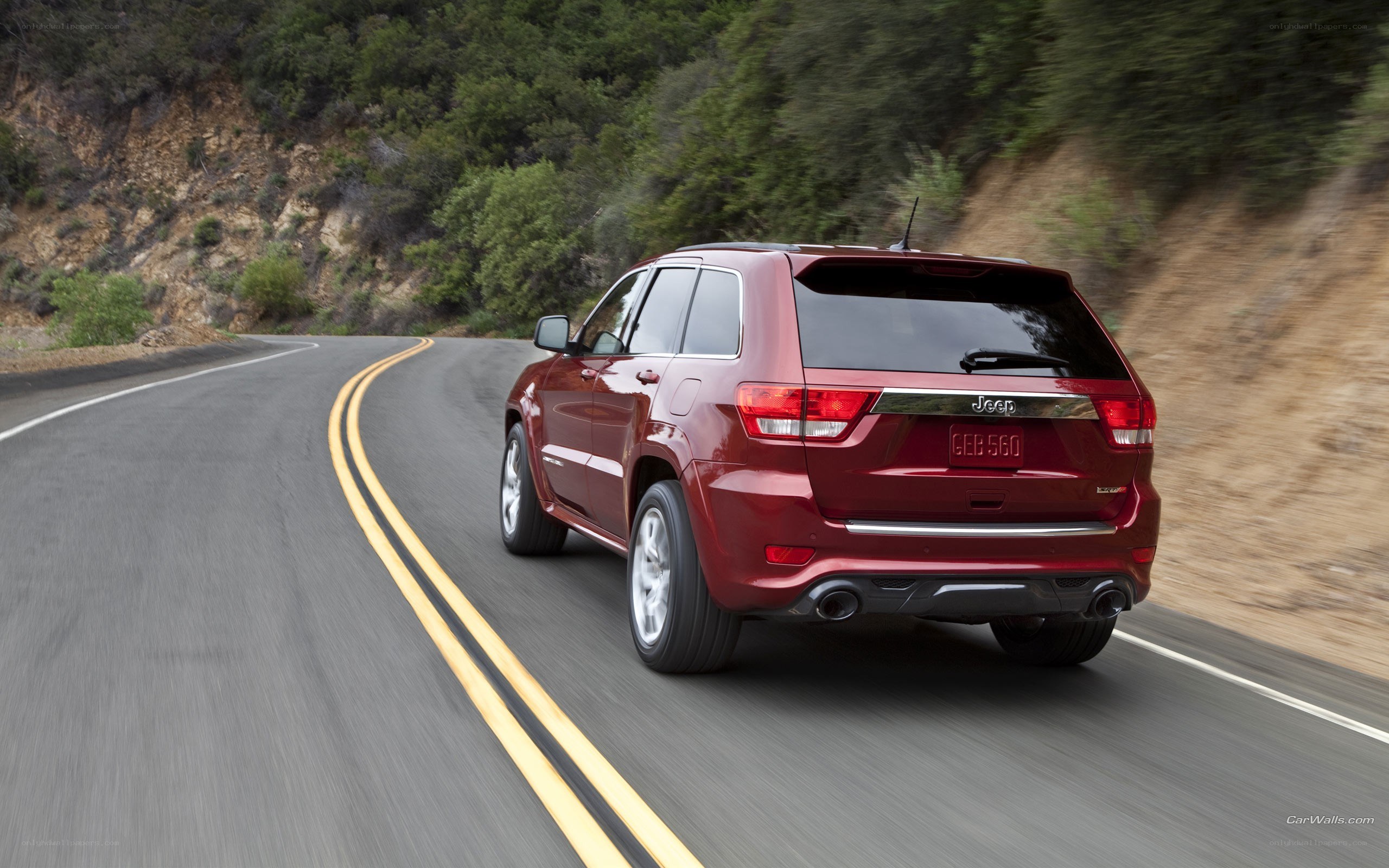 red jeep driving on winding road