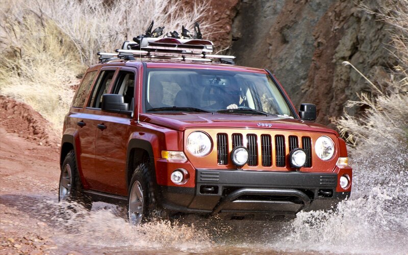 Red Jeep Driving Through Water