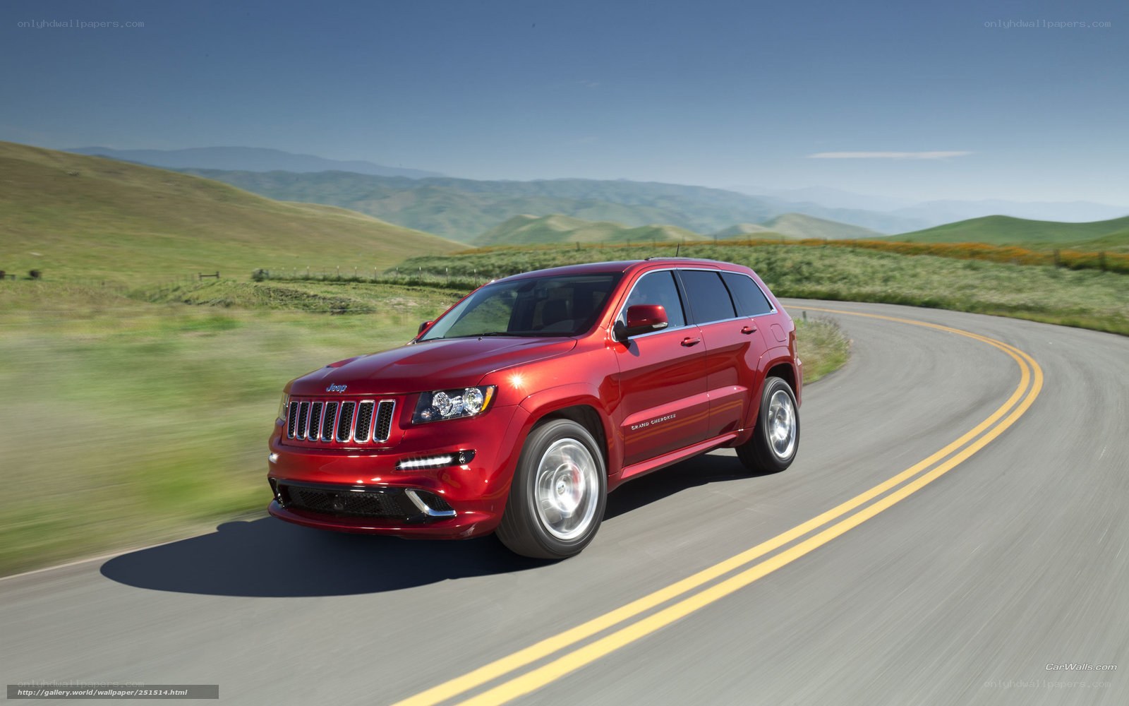 Red Jeep Grand Cherokee on a winding road