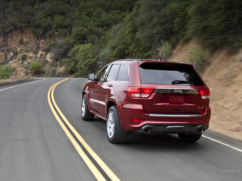Red Jeep Grand Cherokee on a winding road