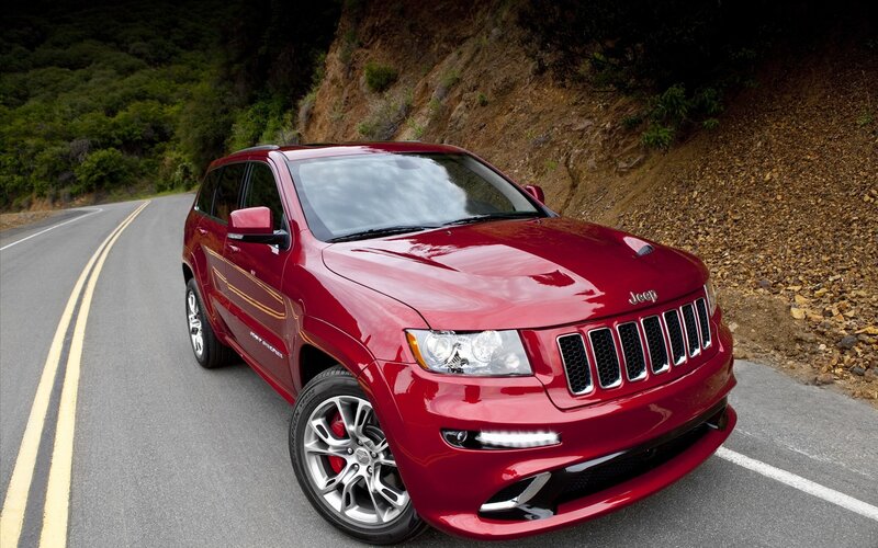Red Jeep Grand Cherokee on mountain road