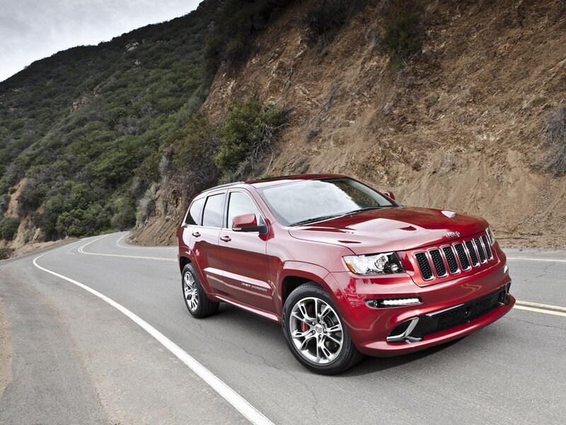 Red Jeep Grand Cherokee on mountain road