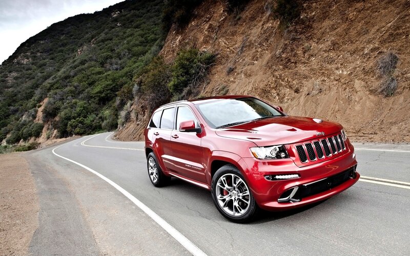 Red Jeep Grand Cherokee on mountain road