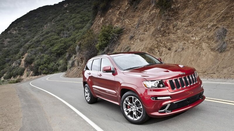 Red Jeep Grand Cherokee on mountain road
