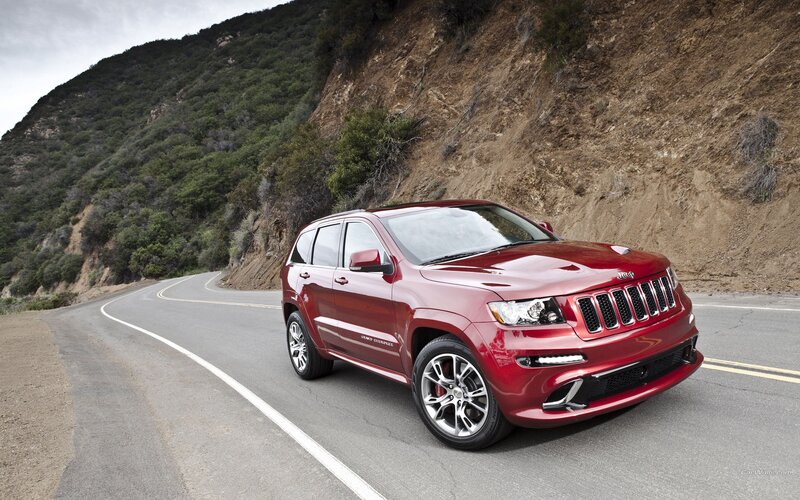 Red Jeep Grand Cherokee on winding road