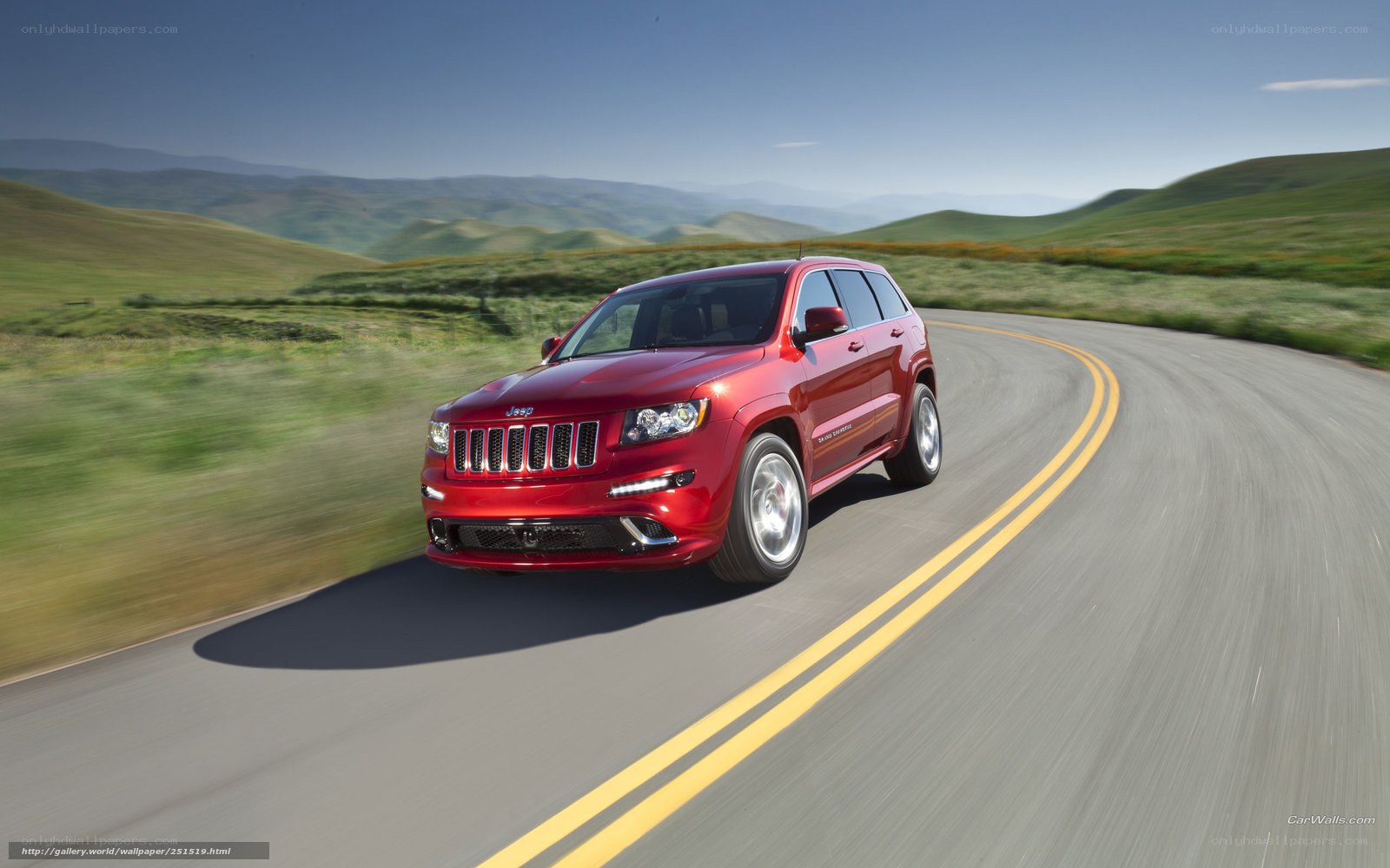 Red Jeep on a winding road