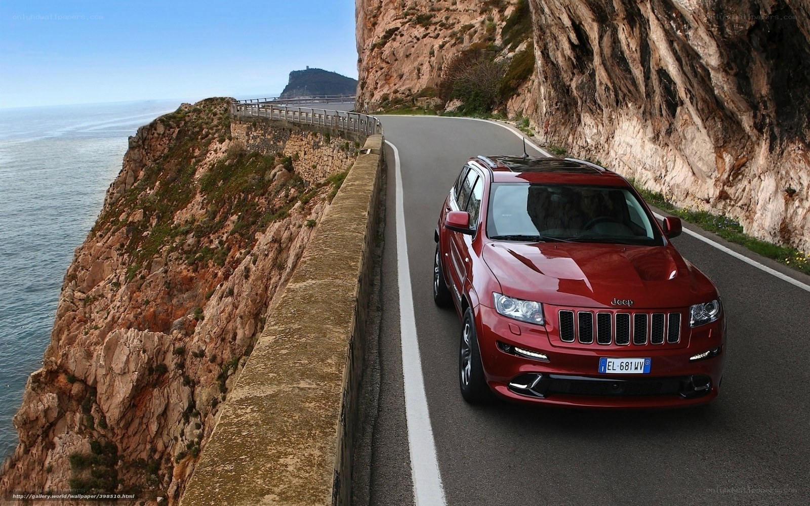 Red Jeep on coastal road