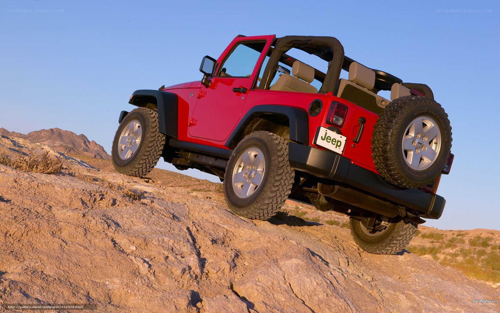 Red Jeep on rocky terrain