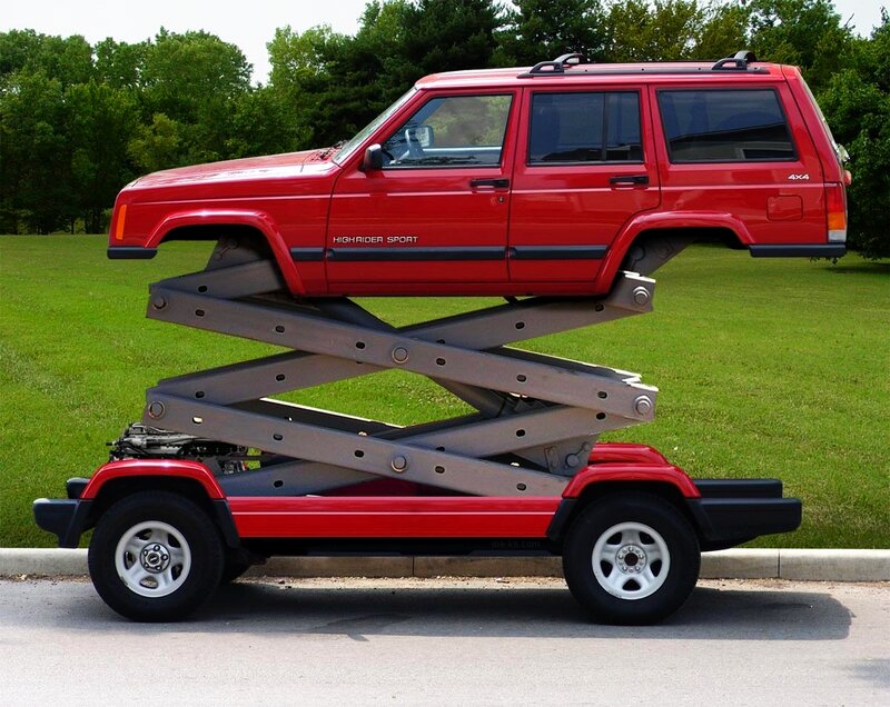 Red Jeep on Scissor Lift