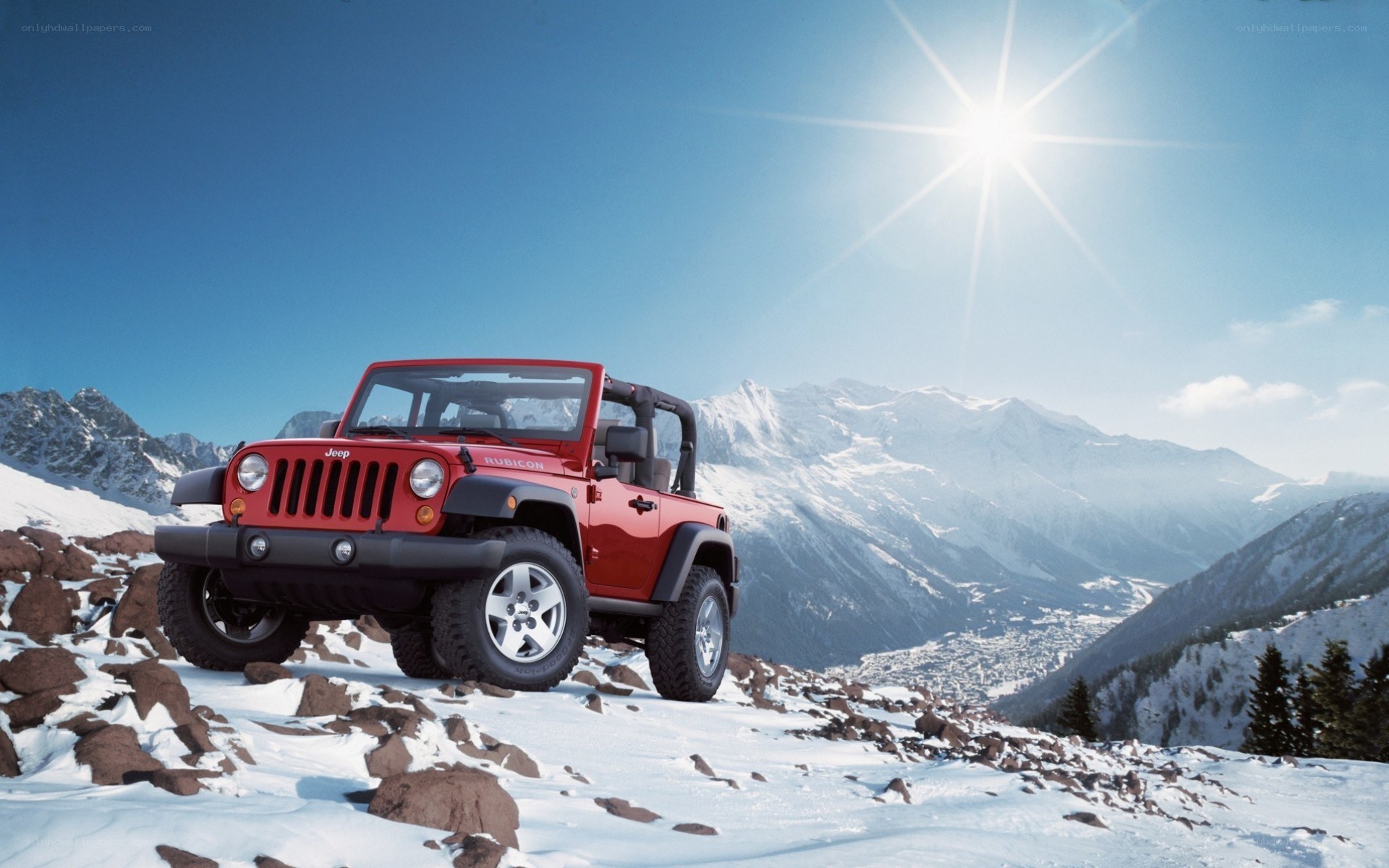 Red Jeep on snowy mountain