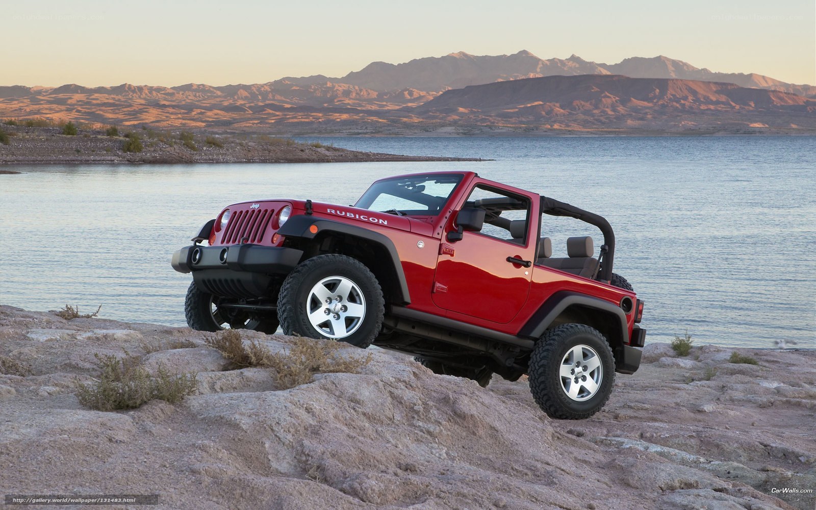 Red Jeep Rubicon by lake