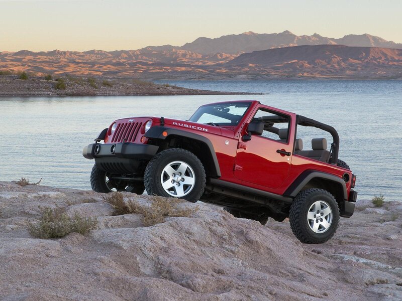 Red Jeep Rubicon by the lake