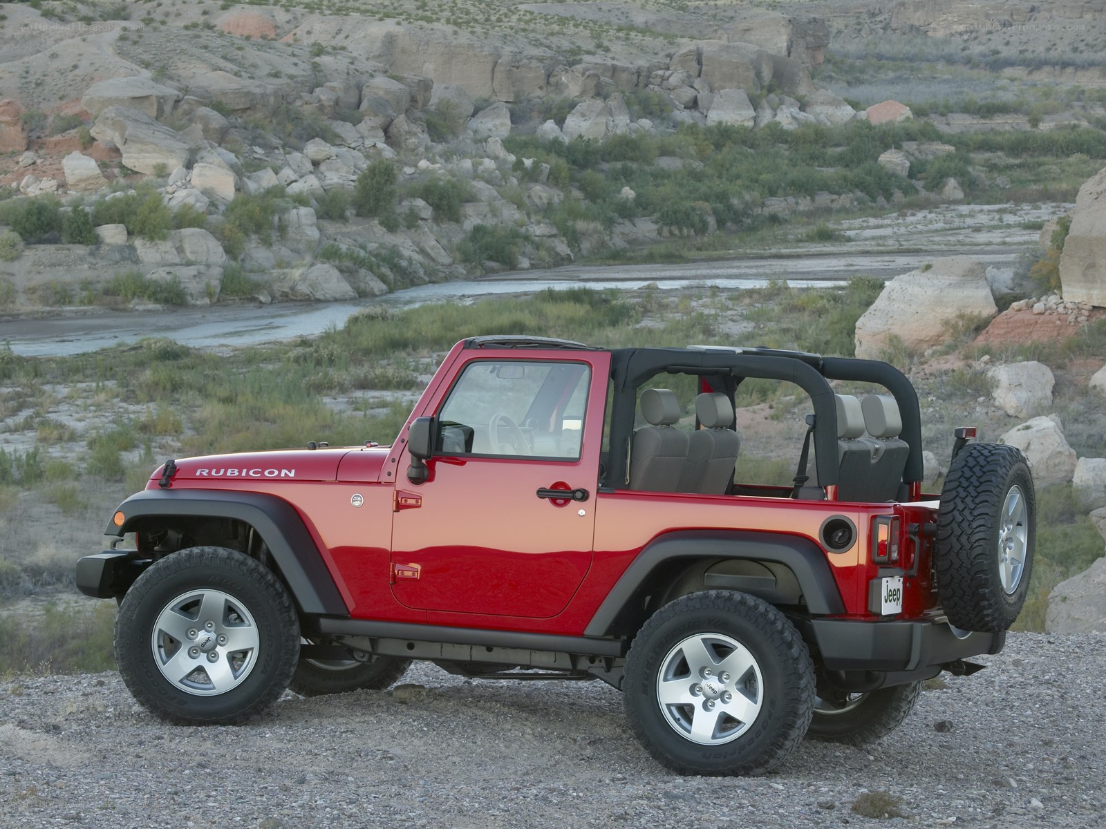 Red Jeep Rubicon in desert