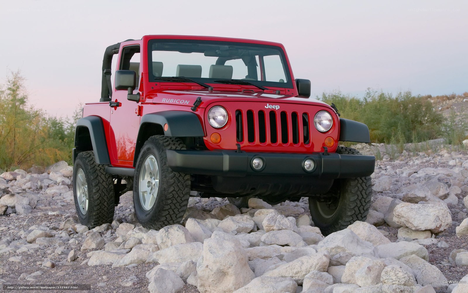 Red Jeep Rubicon on rocks