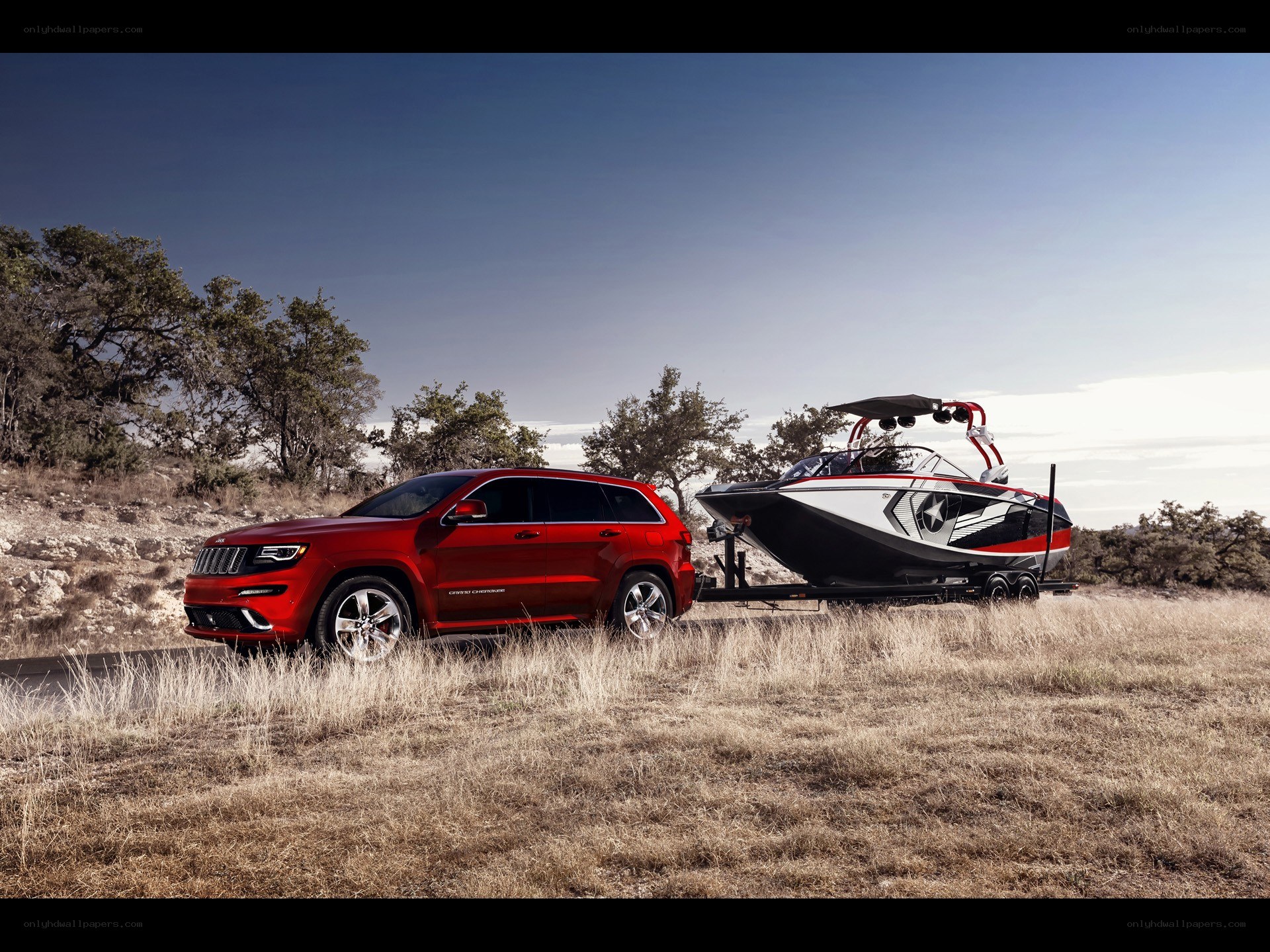 Red Jeep towing a boat