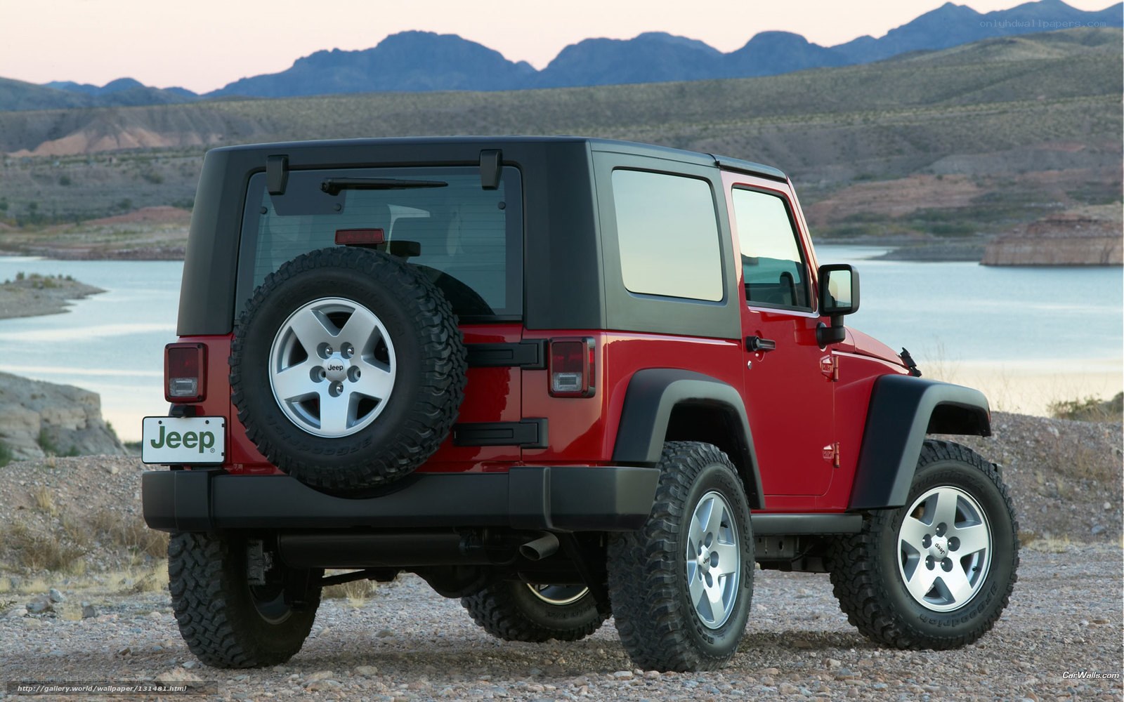 Red Jeep Wrangler by lake