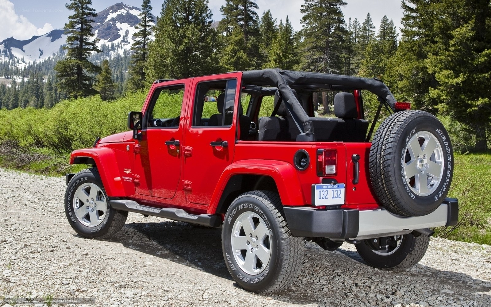 Red Jeep Wrangler in mountain setting