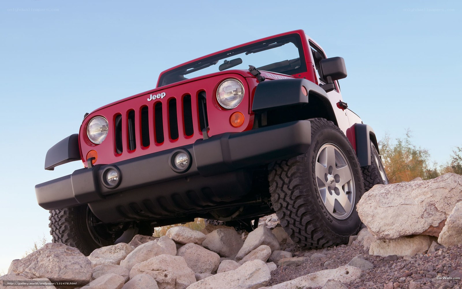 Red Jeep Wrangler on rocks