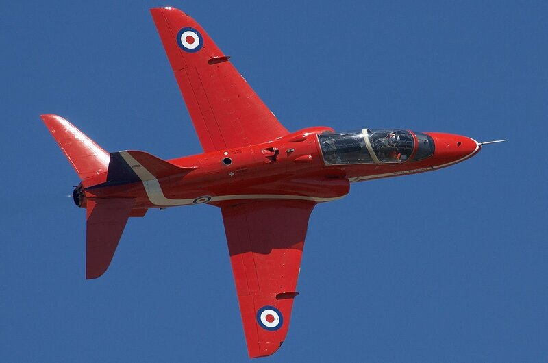 Red jet aircraft in flight