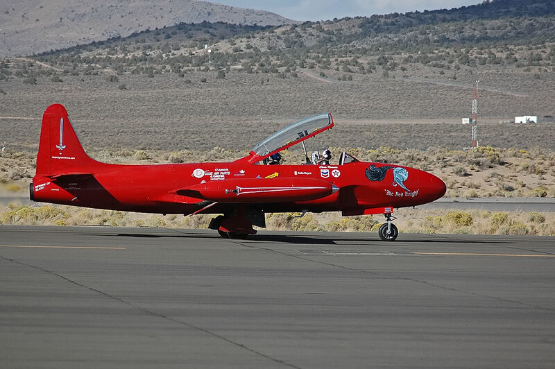 Red Jet on Runway — Calm, Afternoon