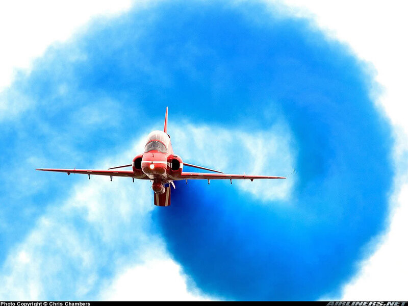 Red jet performing aerobatic display
