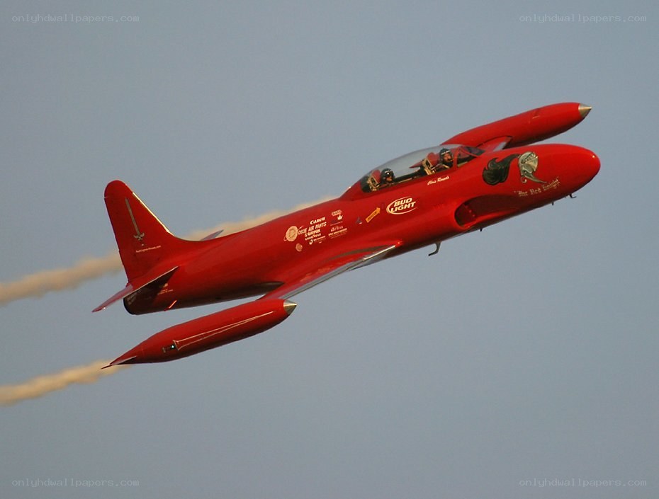 Red jet performing aerobatics