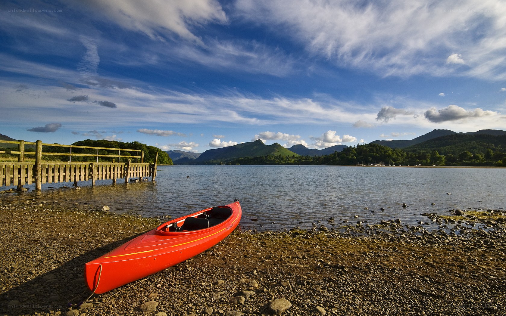 Red kayak on a lakeshore