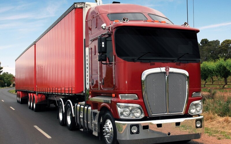 Red Kenworth truck on road