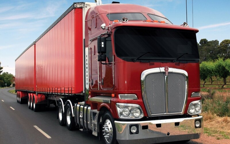 Red Kenworth truck on road