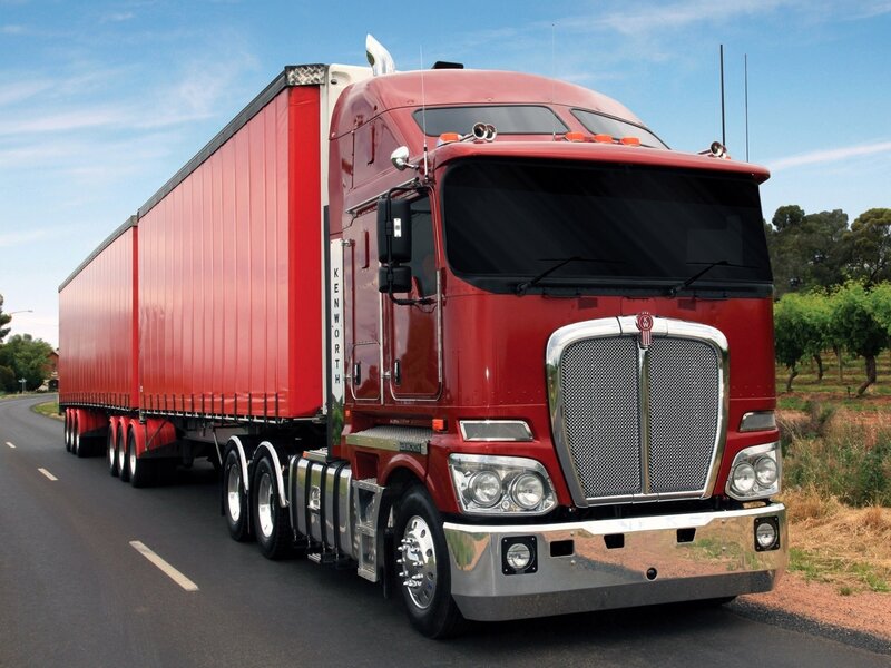 Red Kenworth truck on road
