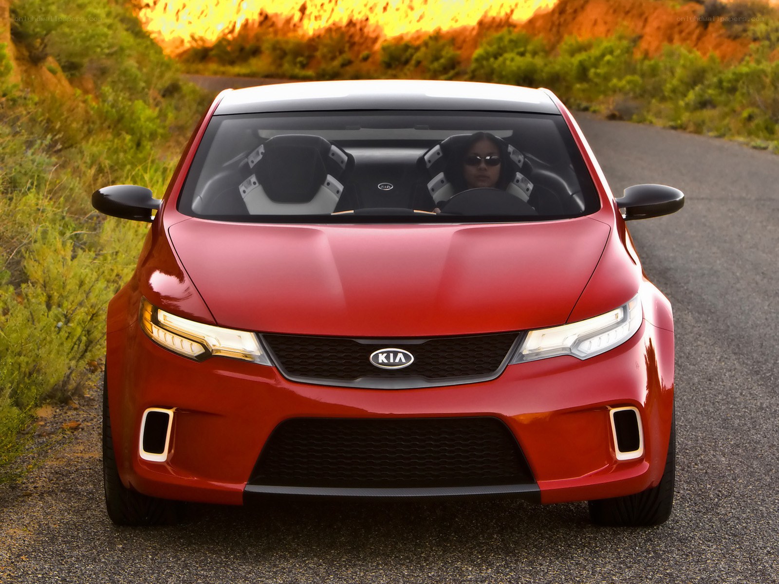 Red Kia concept car on road