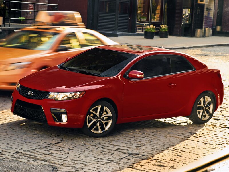 Red Kia Forte Coupe — Urban, Afternoon