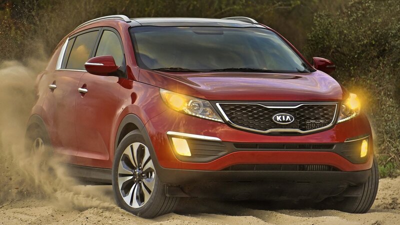 Red Kia Sportage on dirt road