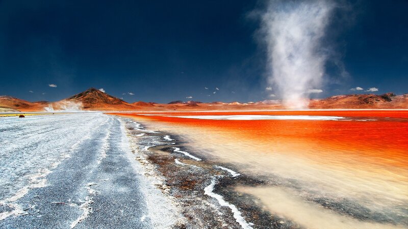 Red lake and geysers in desert