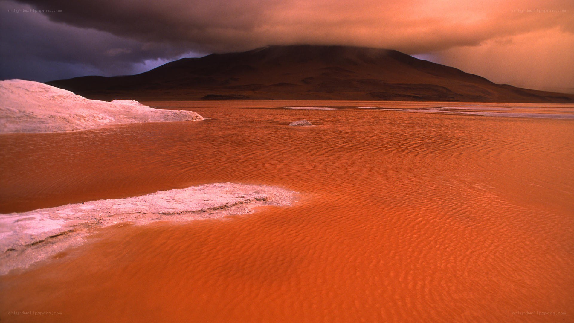 Red lake under stormy sky