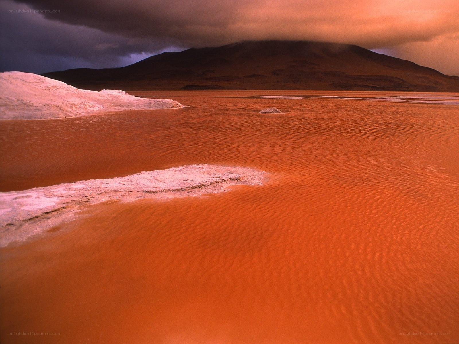 Red lake with salt flats