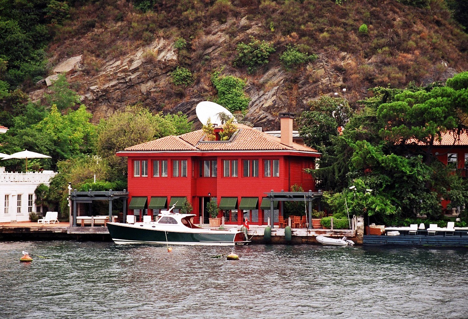Red lakeside house with boat